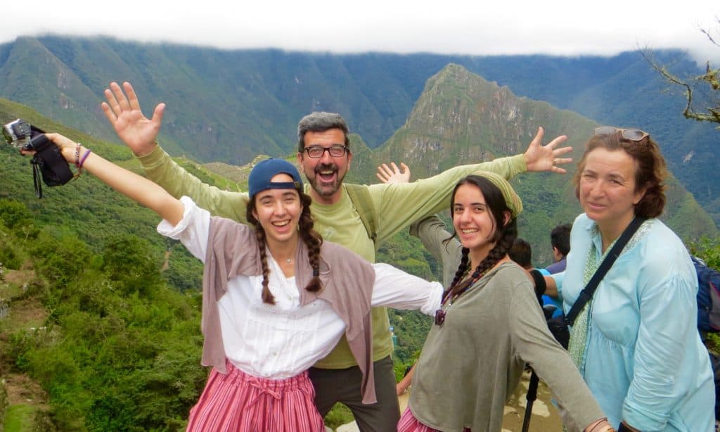 peru-family-holiday, group of trekkers posing in front of machu picchu sun gate, private inca trail