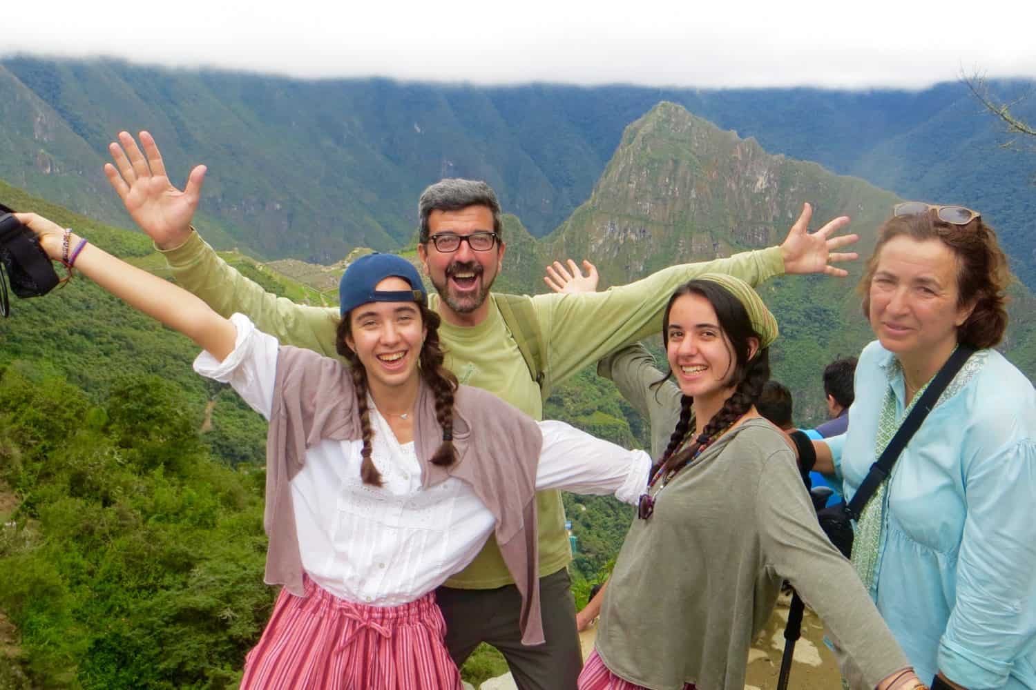 peru-family-holiday, group of trekkers posing in front of machu picchu sun gate, private inca trail