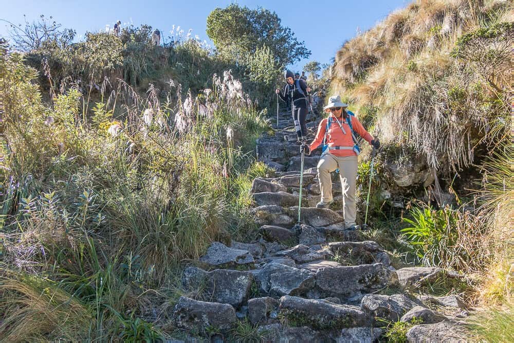 trekker hiking up inca trail steps on private inca trek tour