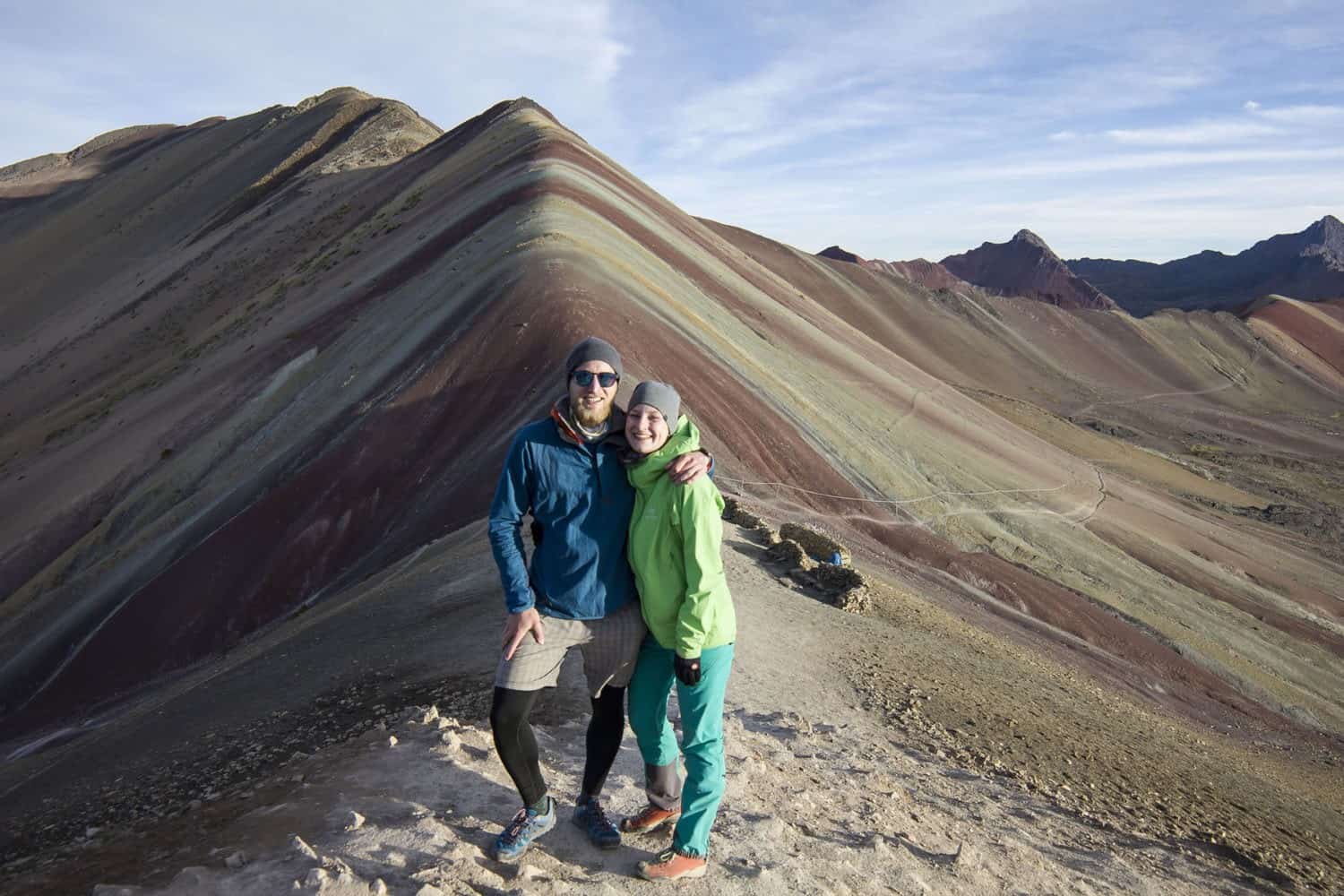 people on top of rainbow mountain