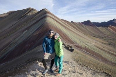 people on top of rainbow mountain