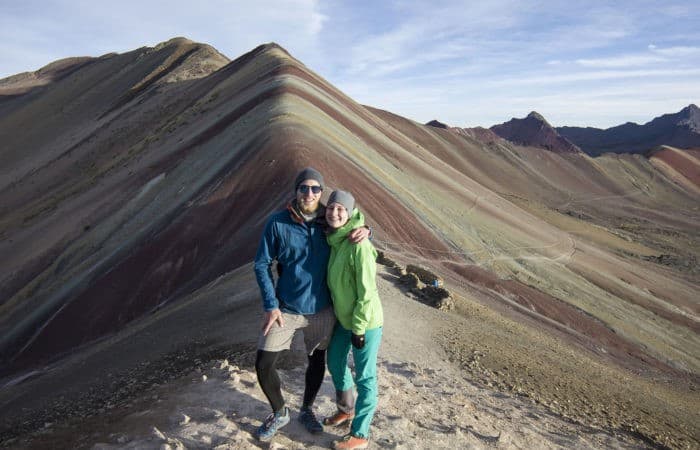 people on top of rainbow mountain