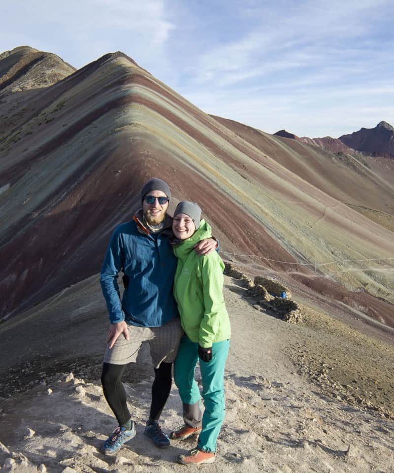 people on top of rainbow mountain