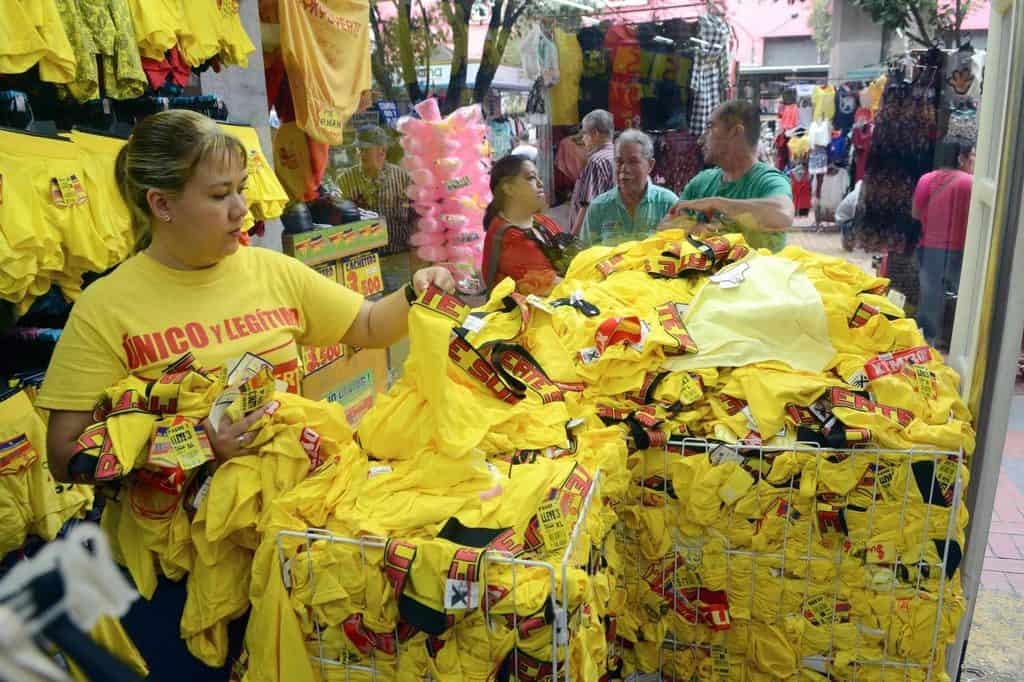 woman buying yellow clothes for new year tradition in peru.