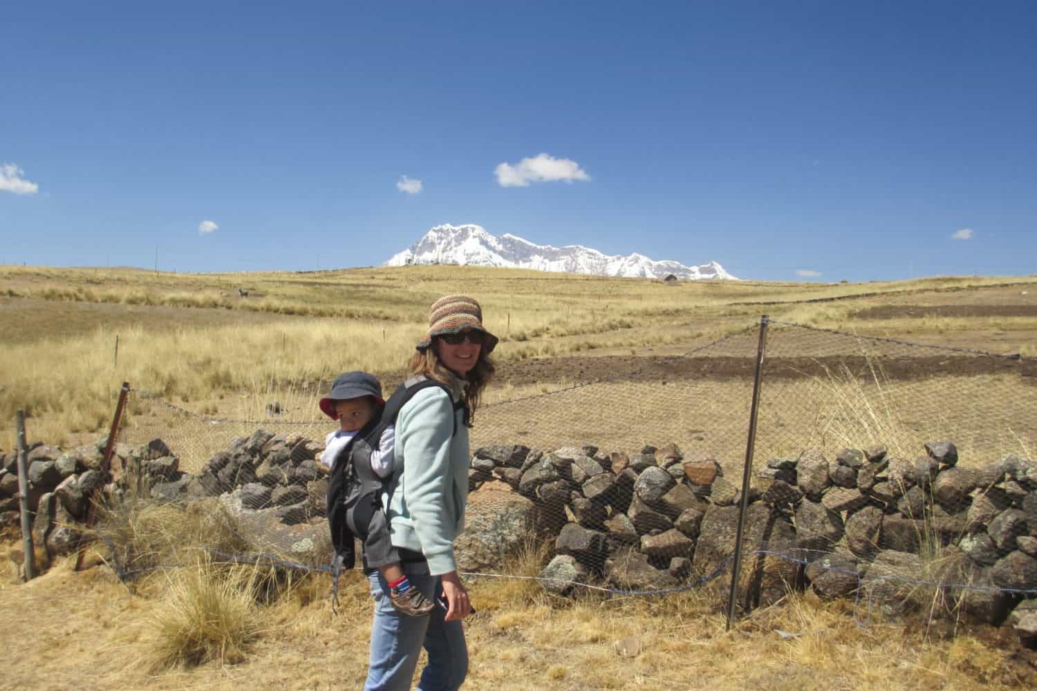 Ausangate-trek-Cusco-with-kids, woman with baby posing in nature landscape