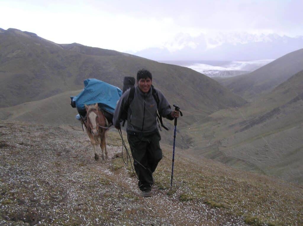 Horseman hiking in the snow 