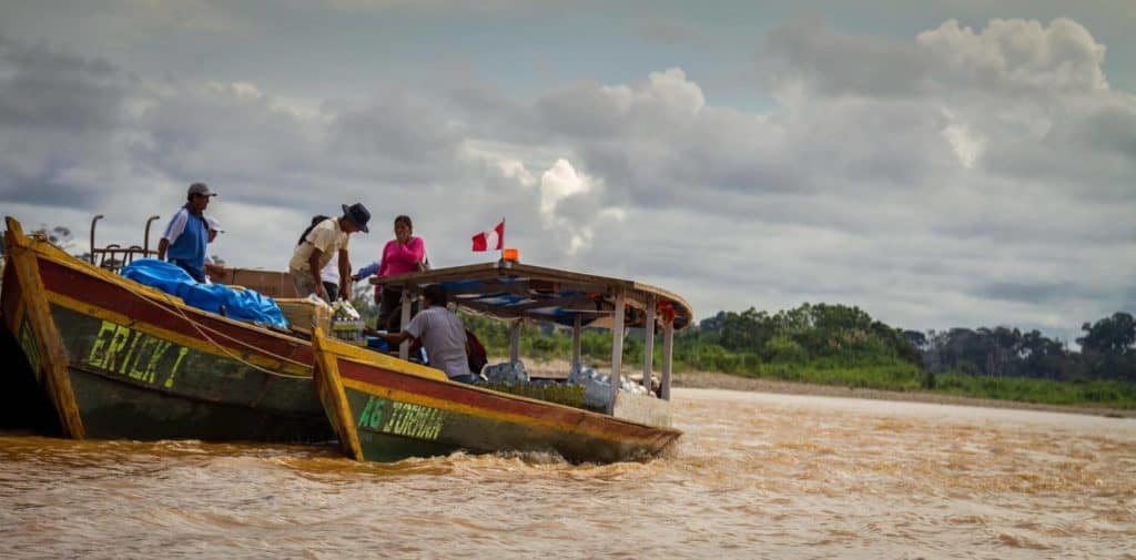 people on a boat in amazon river