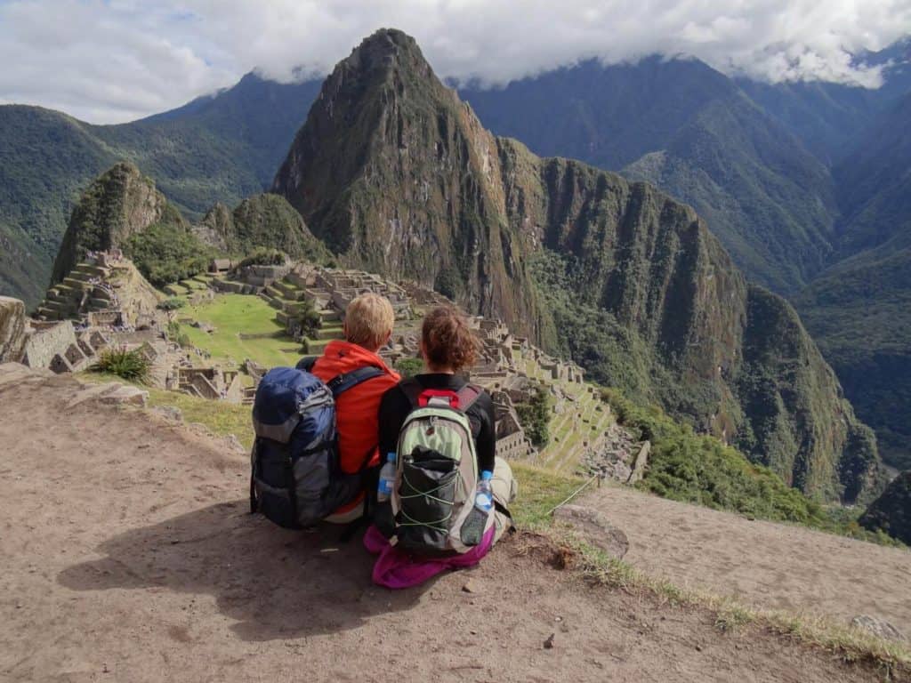 couple sitting in front of machu picchu site, private inca trek