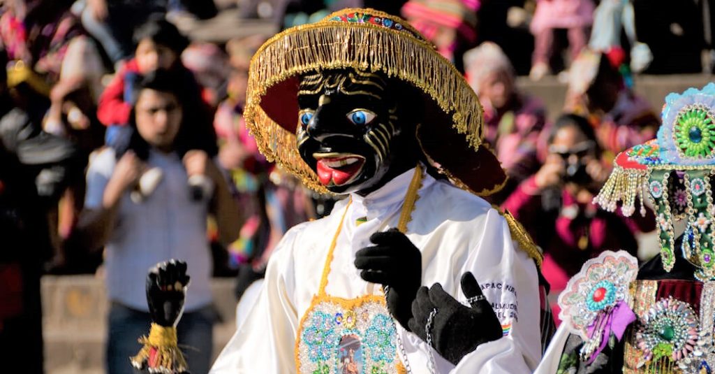 Dancer wearing a black mask during a traditional festival in the streets of Cusco, Peru