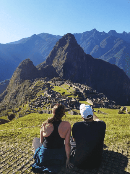 couple sitting in front of machu picchu
