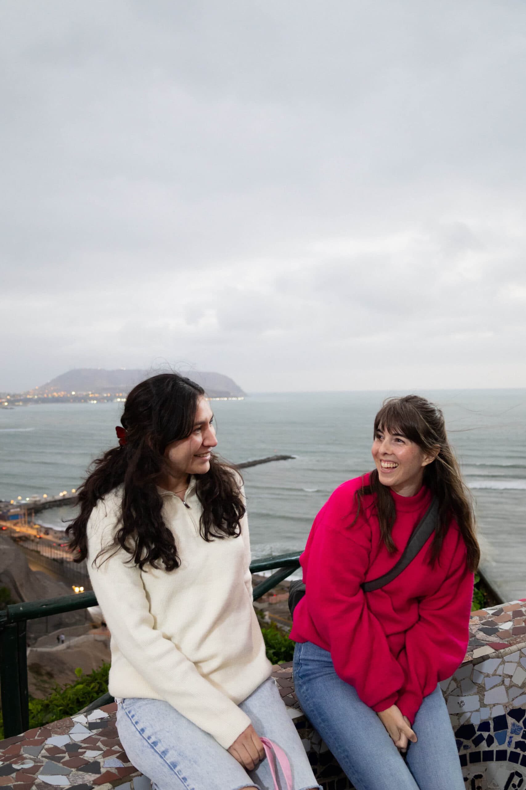 Two women sitting on the malecón in Lima