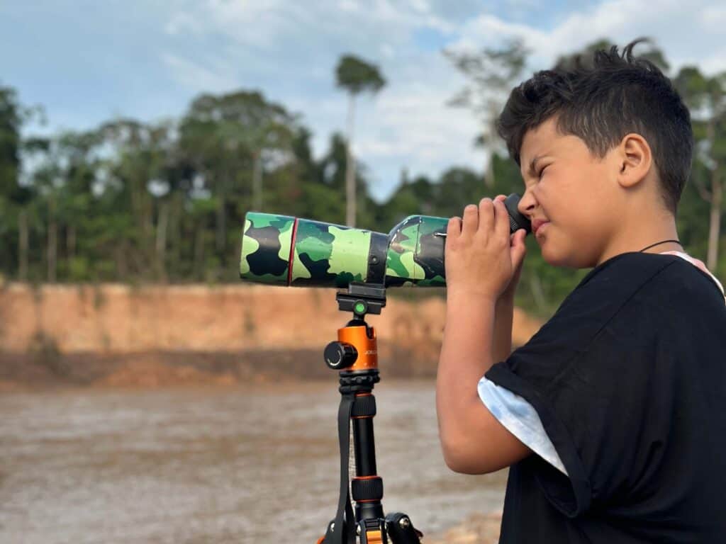 boy looking through binoculars
