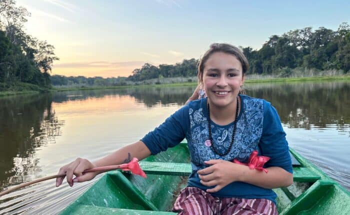 girl in a boat in amazon jungle